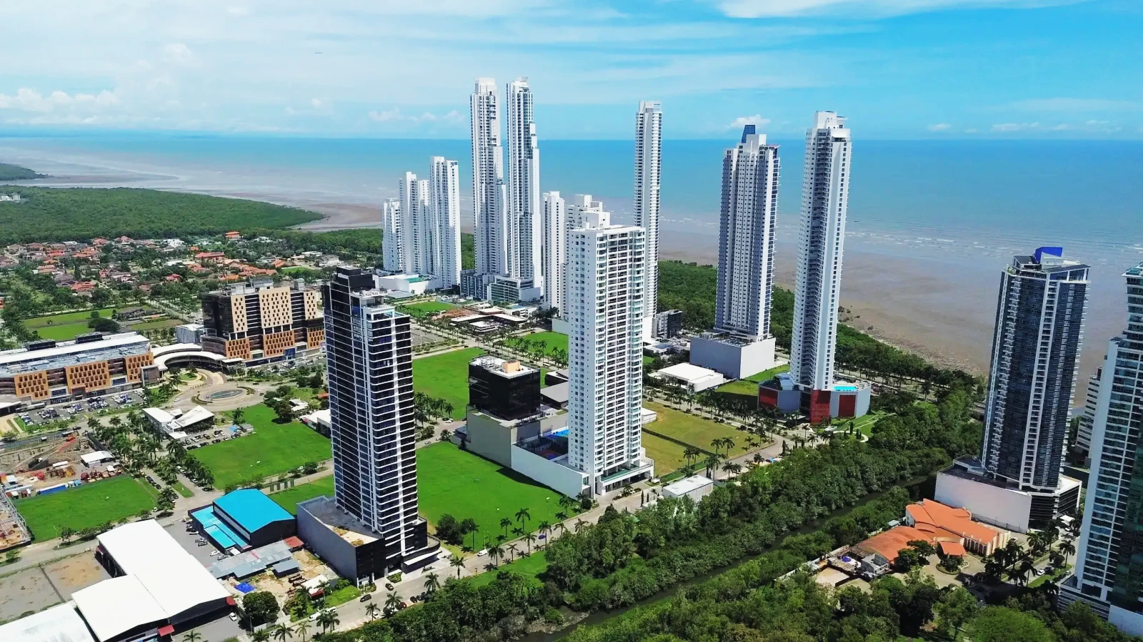 Costa del Este tower line above the retail district, Panama Bay beyond