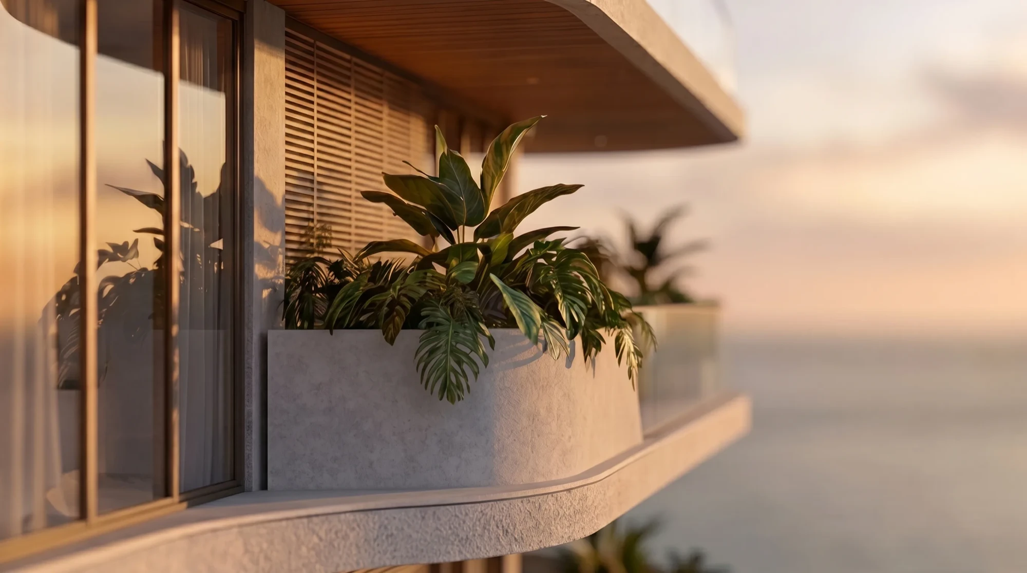 A planted Selvática balcony wrapping the building's corner at sunset, timber soffit and screen above, open water beyond