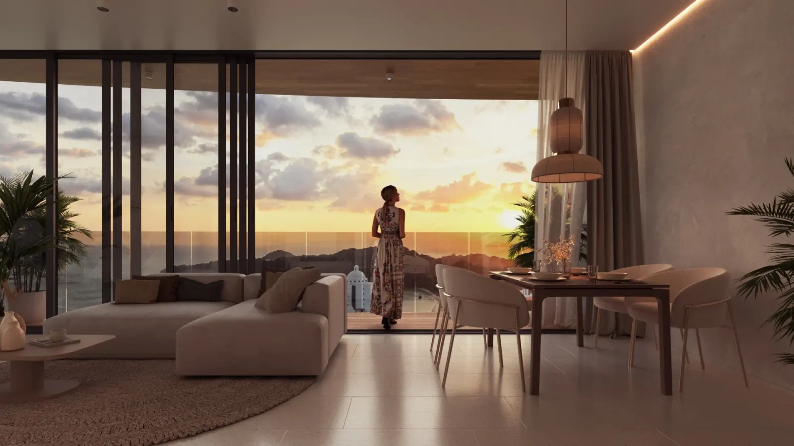 Westin Residences living and dining room opening to a balcony over Playa Bonita at sunset